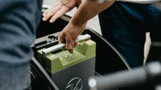 person holding black and green electronic device